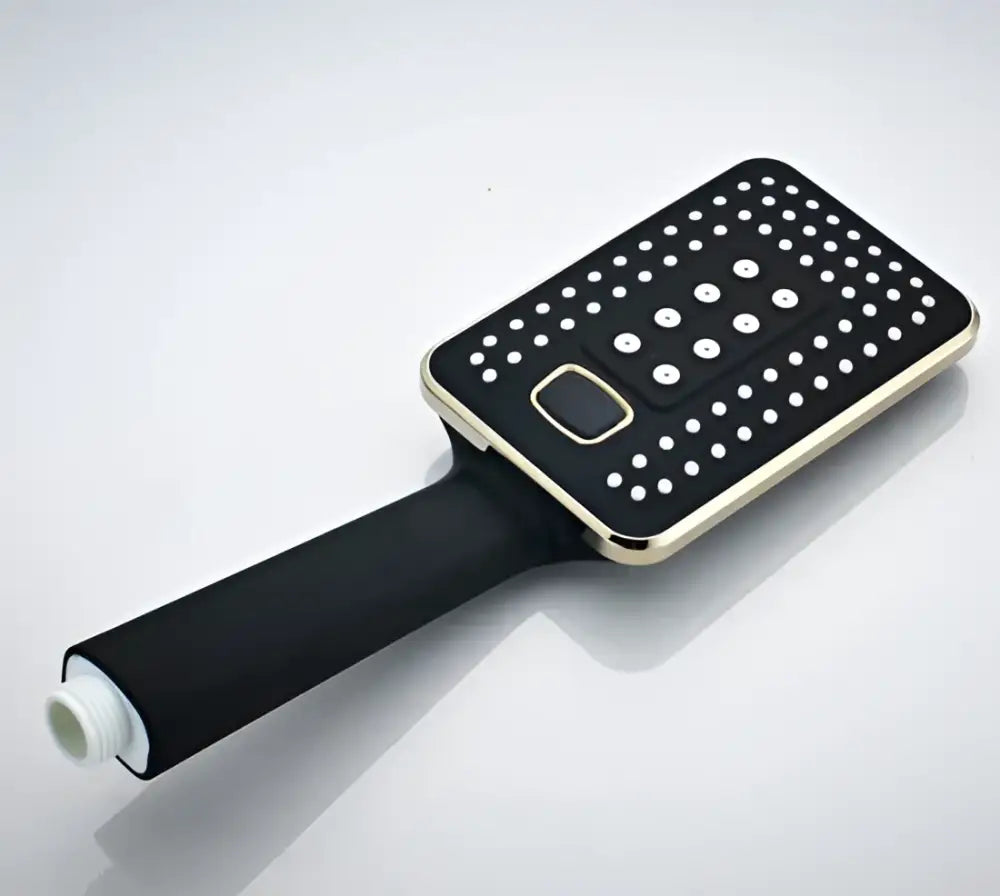 Modern black and gold rainfall shower head with rectangular white perforated face and central control button