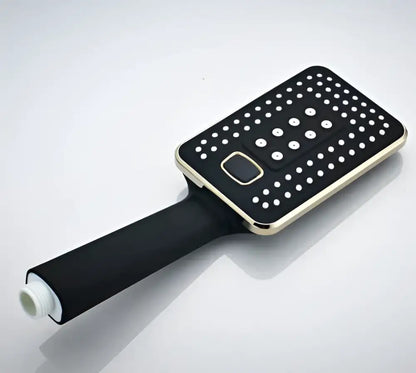 Modern black and gold rainfall shower head with rectangular white perforated face and central control button