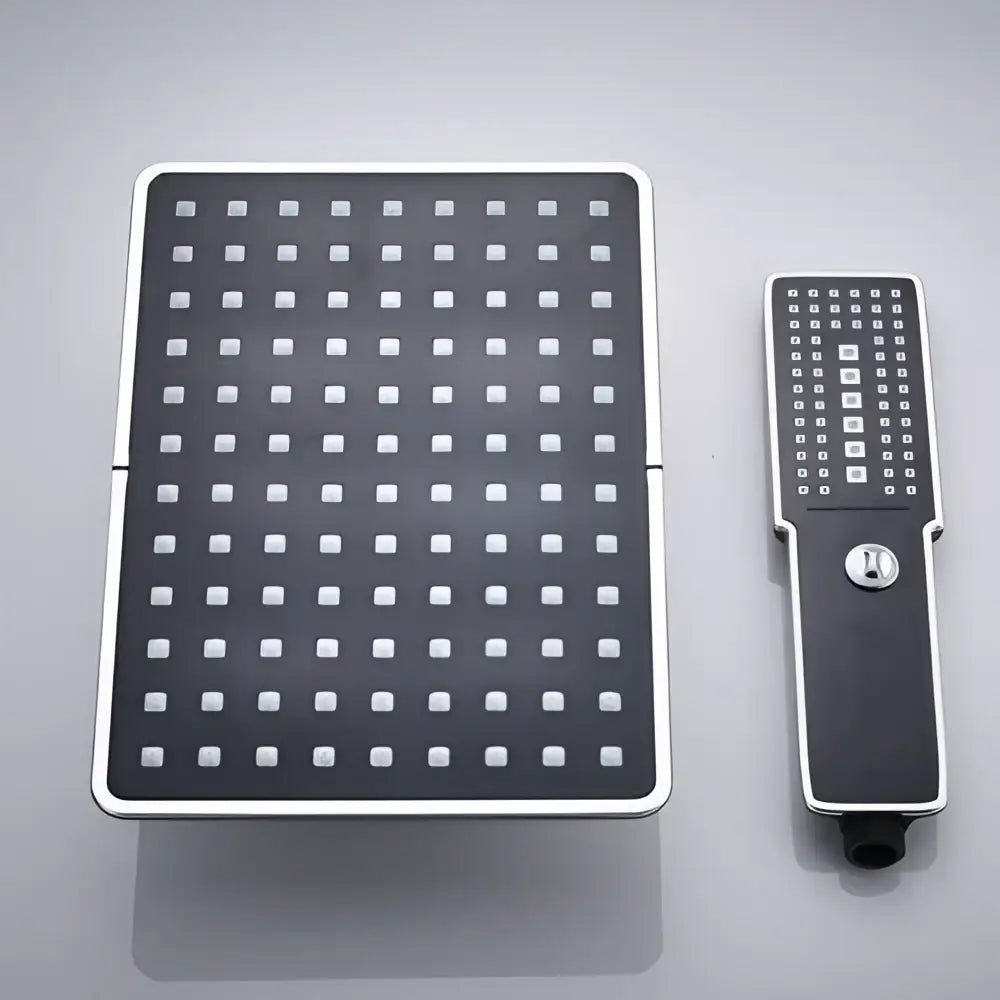 Modern black and chrome rainfall shower head with square rainhead and handheld unit for bathroom use