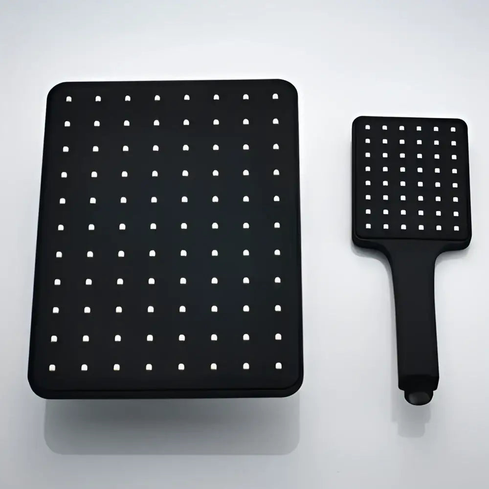 Modern black rainfall shower head and matching handheld showerhead with white nozzles for bathroom use