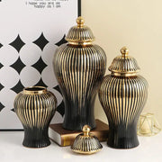 Set of three elegant black and gold ceramic ribbed ginger jar vases with matching golden lids for living room decor