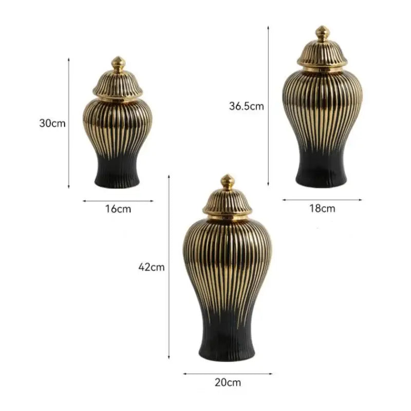 Set of three modern black and gold ceramic ginger jar vases with ribbed vertical patterns and matching golden lids