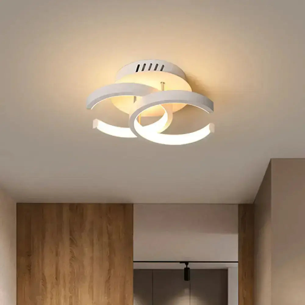 Modern white circular ceiling lamp with three interlocking rings and warm glow offering exceptional lighting efficiency