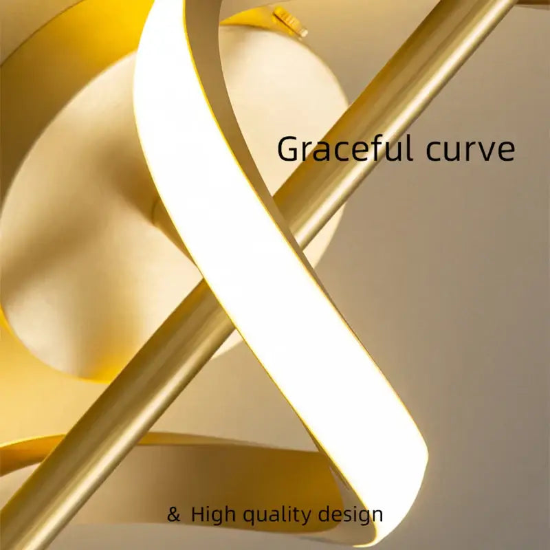 Modern black and gold pendant light with a gold-toned copper lamp body and intertwined spiral design for dining rooms
