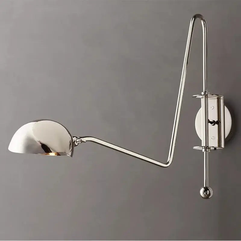 A sleek chrome wall lamp with curved swing arm and adjustable dome shade for modern decorbites black gold living room decor