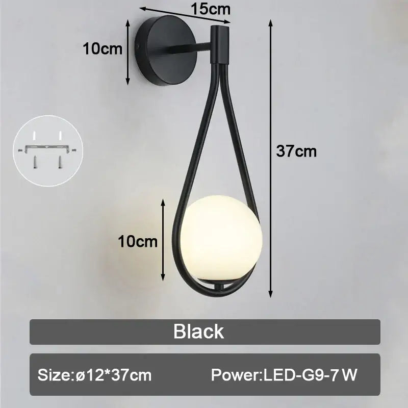 Modern black and gold led wall sconce with teardrop frame and frosted glass globe for bedroom lighting