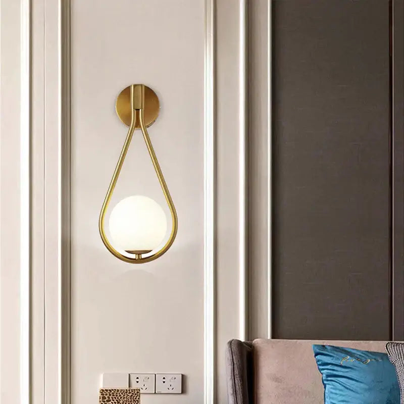Modern black and gold teardrop led wall sconce with frosted glass globe for bedroom lighting