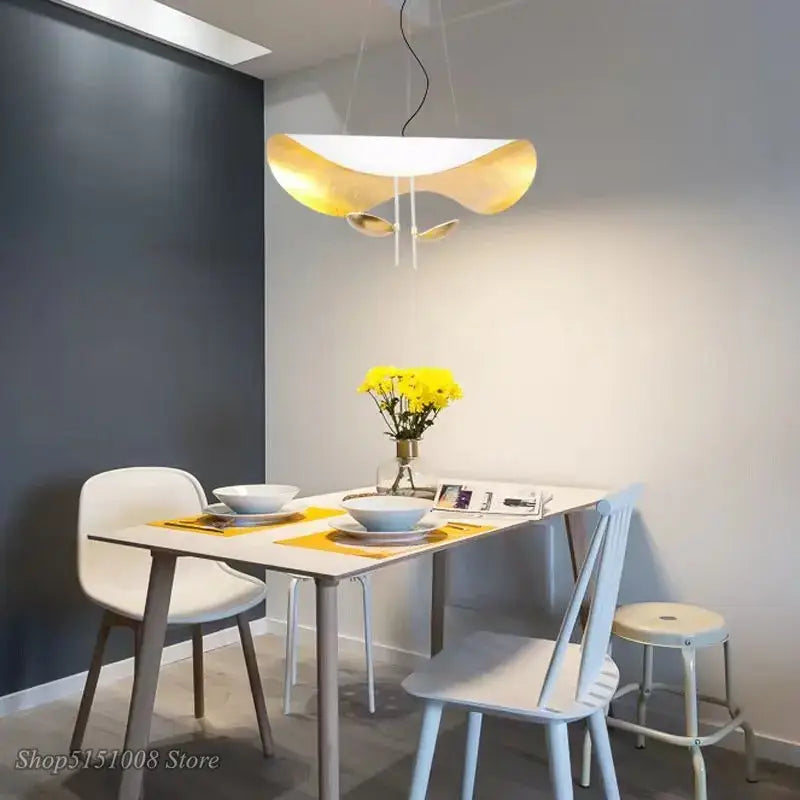 Modern black and gold texture led pendant lights featuring a sculptural gold and white design above dining table