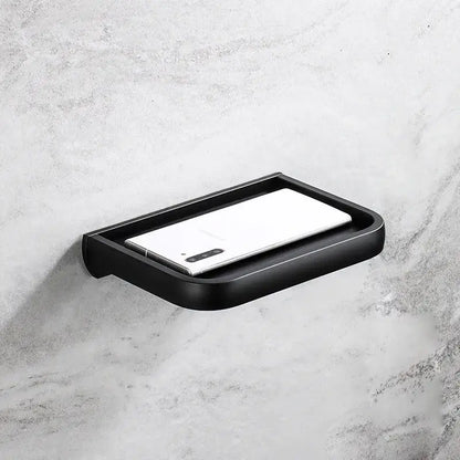 Modern black tissue paper holder with gold accents and black matte soap dish for bathroom storage and organization