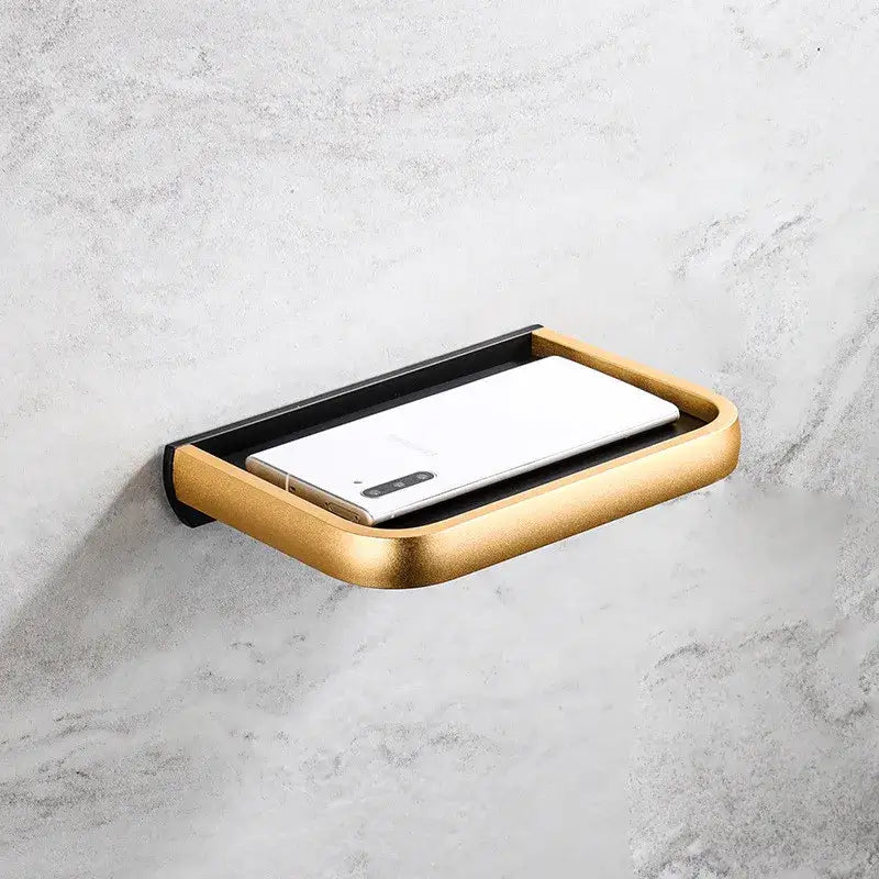 Modern black and gold tissue paper holder with phone tray featuring a sleek wall-mounted soap dish design