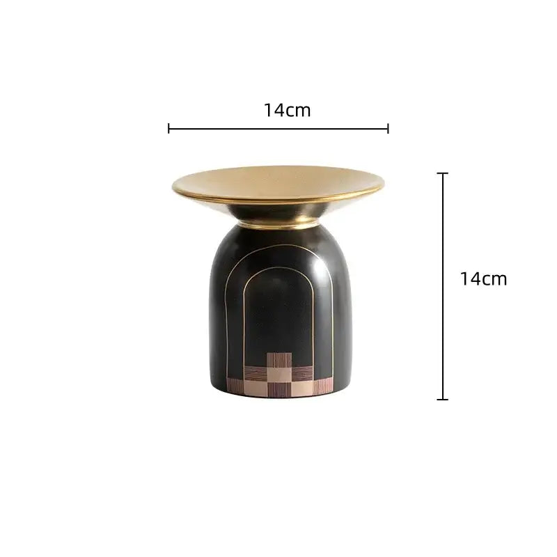 A sleek black and gold accent table with polished brass top and wood inlay for modern decorbites golden tray vase decor