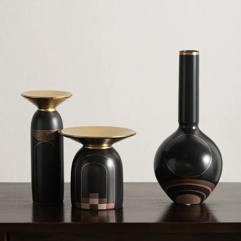 Set of three modern black ceramic vases with gold accents and geometric inlay patterns for decorbites golden tray decor