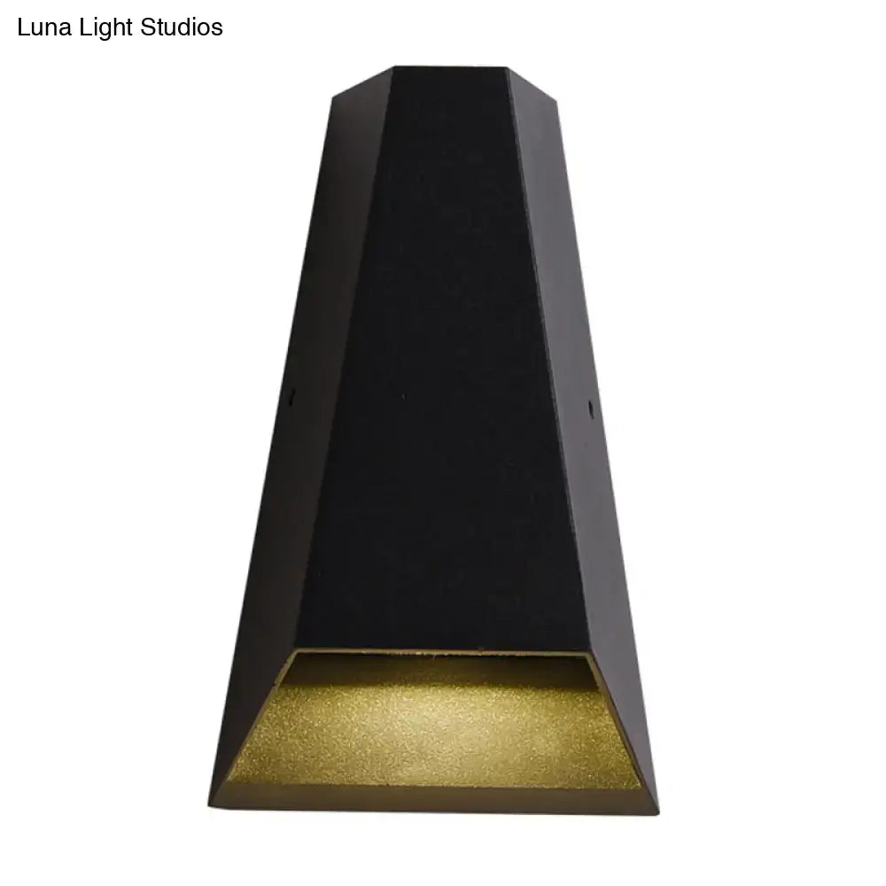 Modern black hexagonal led wall light with gold textured diffuser providing warm white light for bedroom use