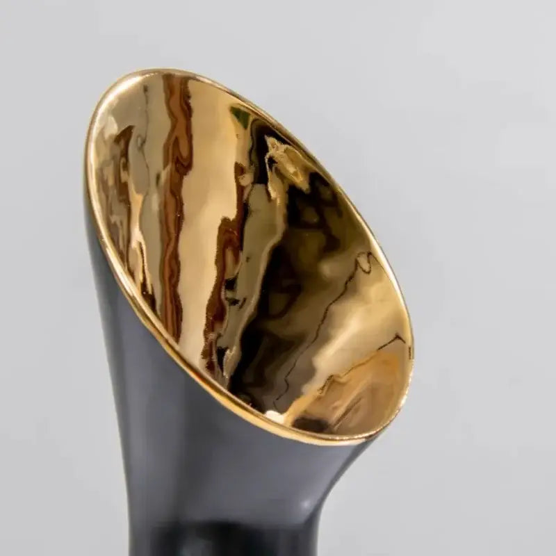 A sleek black and gold trumpet ceramic flower vase with glossy gold interior rim and swirling golden patterns for decorbites golden trumpet decor