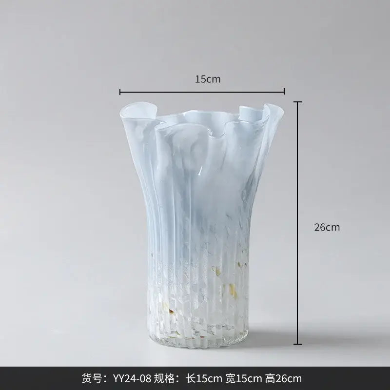 Translucent light blue glass vase with fluted ruffled rim and ribbed texture complementing decorbites golden trumpet ceramic set