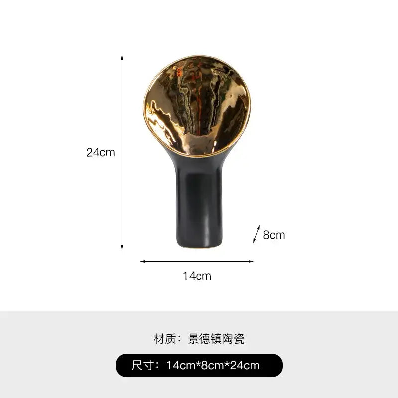 A sleek modern black and gold trumpet ceramic flower vase with glossy base and reflective golden trumpet ceramic interior decorbites
