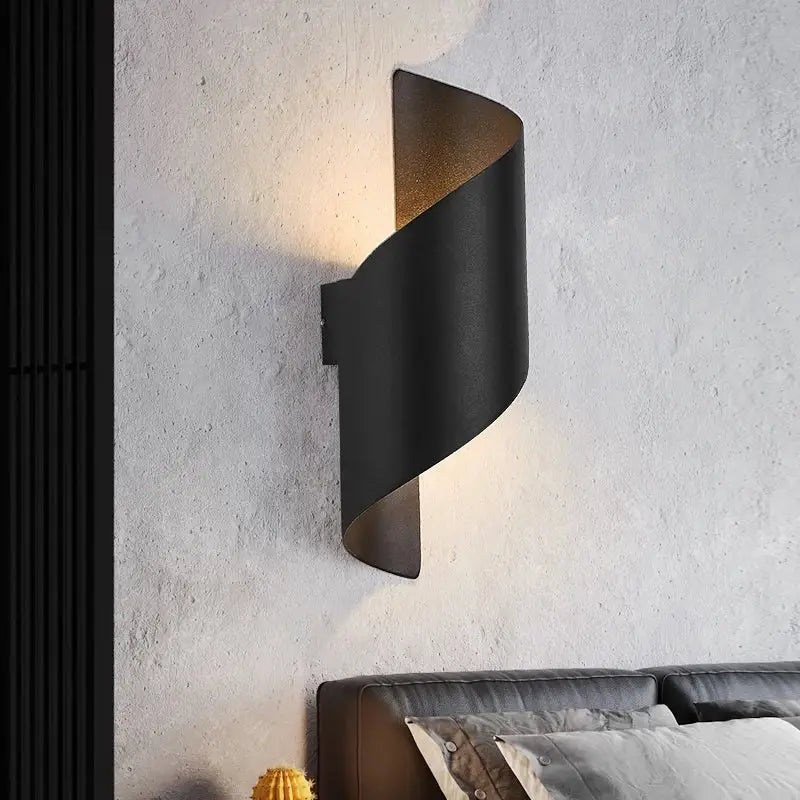Modern black metal wall lamp with curved design and warm led interior lighting for corridor use