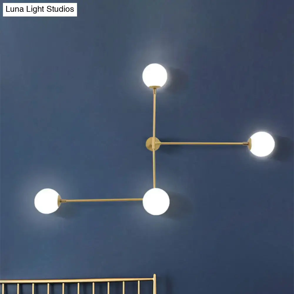 Modern brass wall lamp with three white glass globes in black and gold direct wired electric design for bedrooms