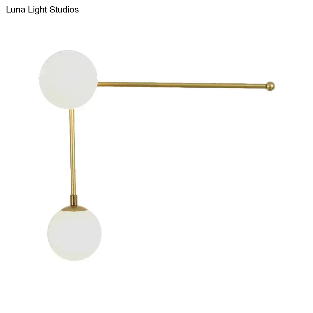 Modern black and gold wall lamp with direct wired electric brass fixture and two frosted glass spheres in modern design