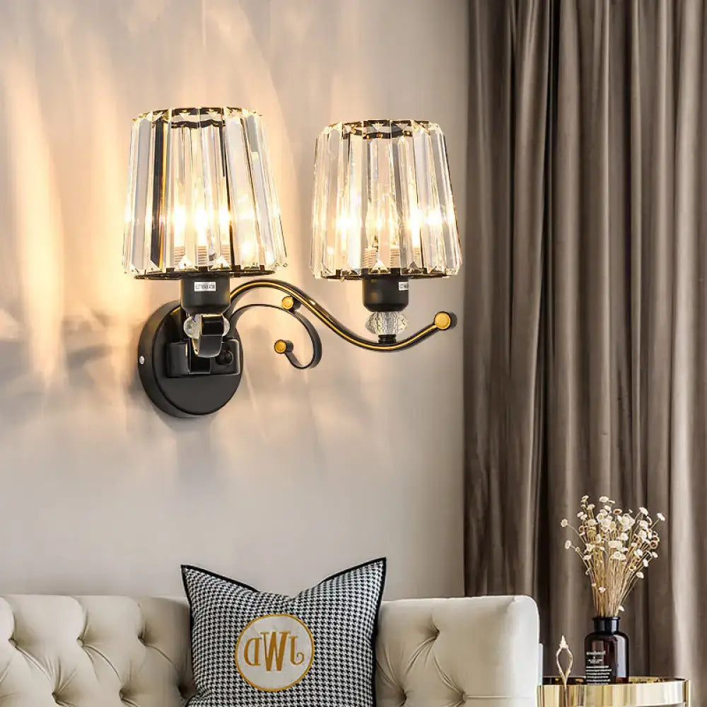 Modern black and gold wall lamp with clear glass crystal lights and ornate curved arm for bedroom sconce lighting