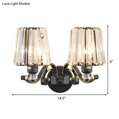 Modern black and gold wall lamp with clear glass crystal shades designed as a two-light bedroom sconce
