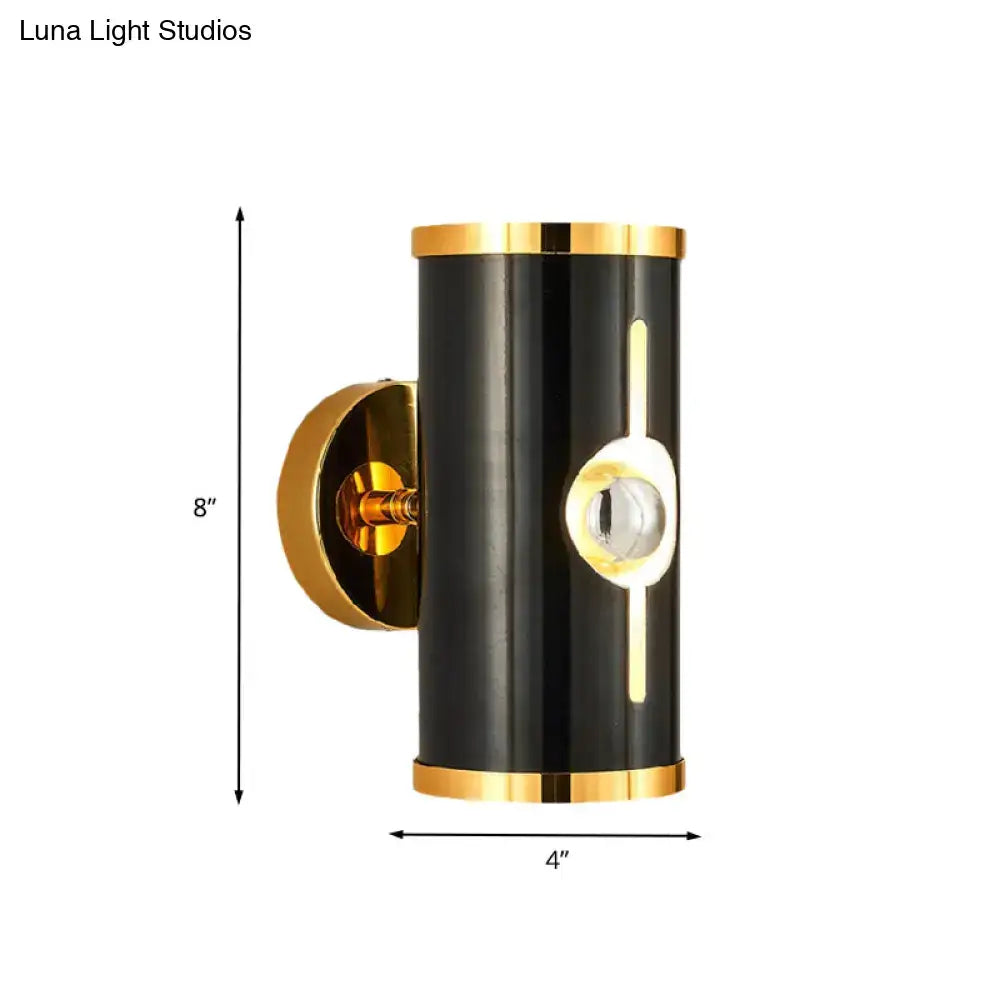 Modern black finish wall lamp with gold accents and vertical light strip for stylish bedroom sconce lighting