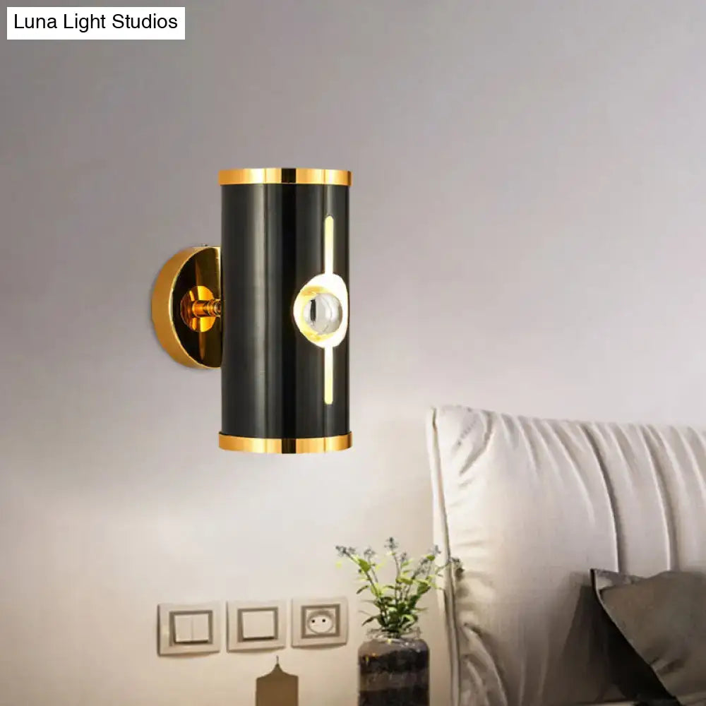Modern black finish wall lamp with gold accents and central circular light fixture for bedroom sconce lighting