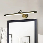 Modern black and gold wall light fixture with matte black cylindrical bar and ornate gold base for dressing table