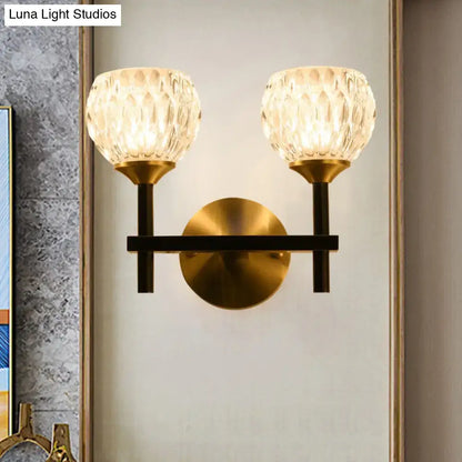 Gold-toned wall light with two faceted dimpled glass shades for living room modern black and gold design