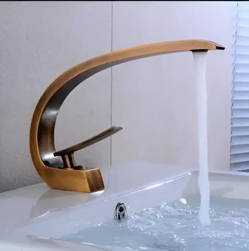 Bronze-finished curved modern black gold basin faucet featuring sleek waterfall design for bathroom decorbites black gold collection
