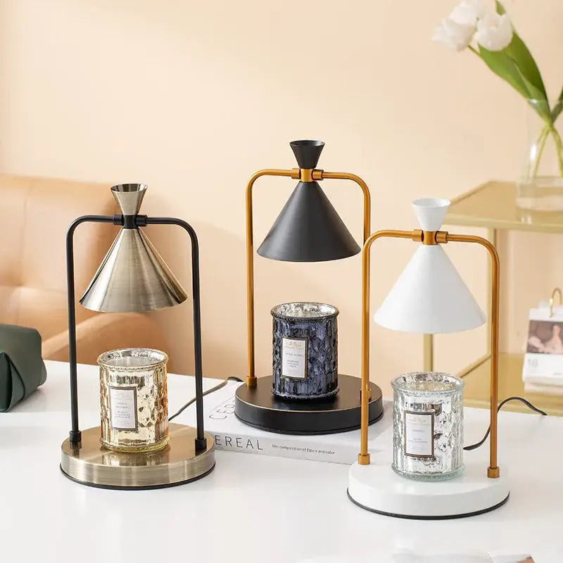 Three modern decorbites candle warmer lamps with sleek metal frames and conical lampshades in black gold and white