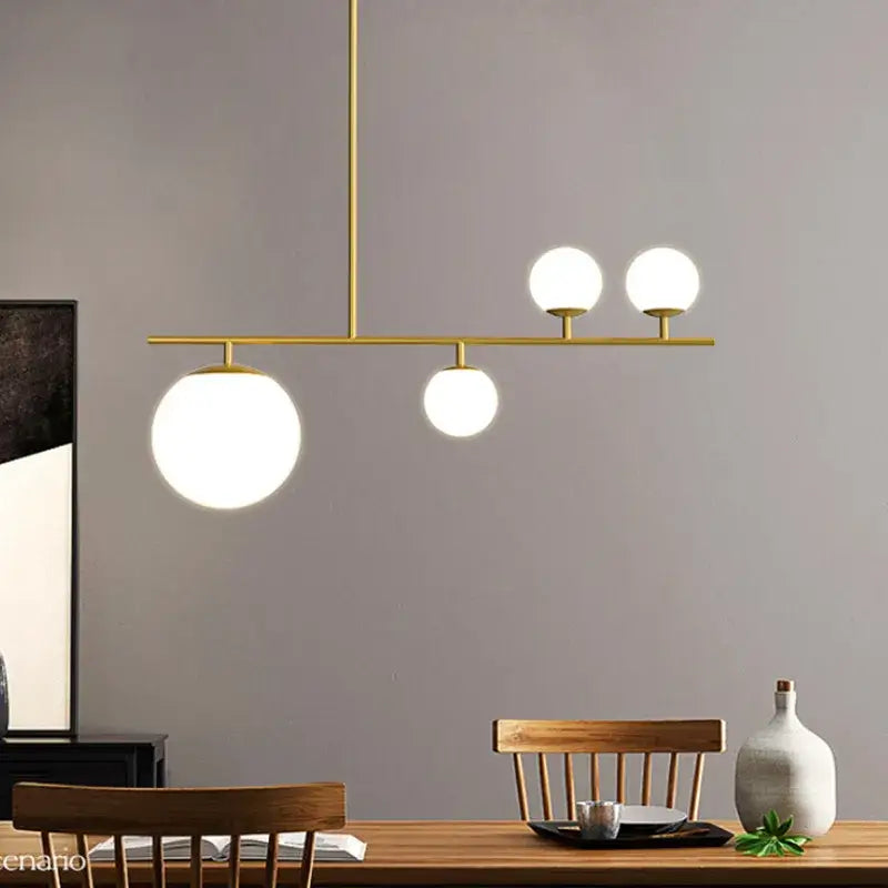 Modern black and golden glass chandelier kitchen pendant light with gold-toned frame and four frosted spherical bulbs decorbites black golden
