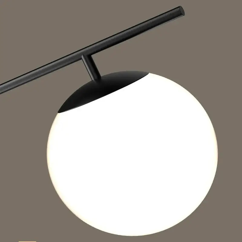 Modern black golden glass chandelier kitchen pendant light with black metal arms supporting a glowing white spherical lampshade