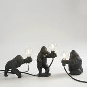 Three black resin gorilla figurine lamps holding glowing bulbs modern decorbites gorilla night light for bedroom