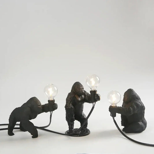 Three black resin gorilla figurine lamps holding glowing bulbs modern decorbites gorilla night light for bedroom