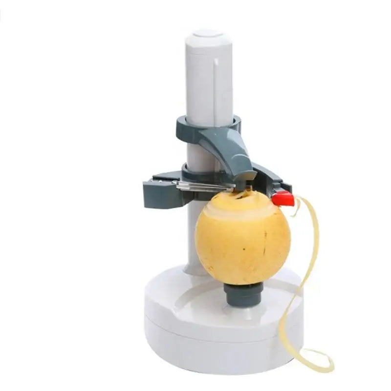 Modern black and gray electric peeler with red button actively peeling a yellow apple using a fruit slicer gadget