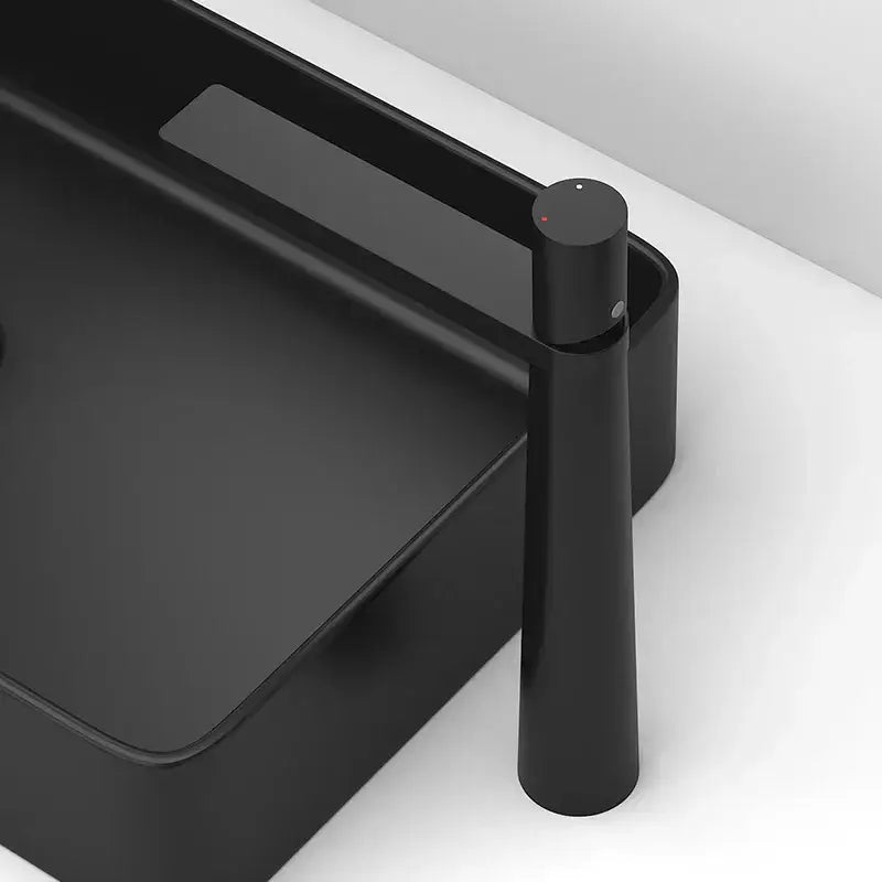 Modern black and grey brass basin faucet with matte finish and sleek cylindrical design by decorbites basin faucet