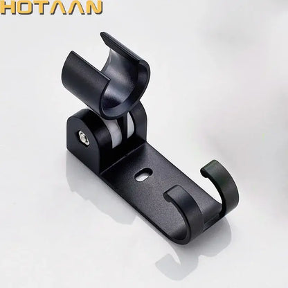 Modern black plastic hand shower holder with curved hook and adjustable wall mount bracket for bathroom organization