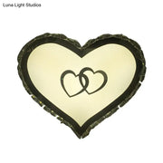 Modern black heart crystal shade wall sconce with textured frame and interlocking hearts for bedroom lighting