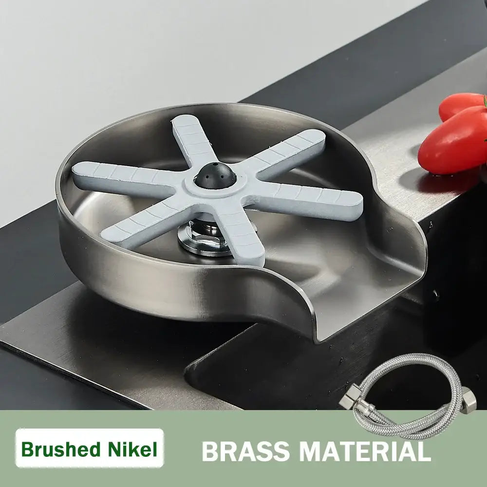 Modern black high pressure glass cup washer with brushed nickel sink drain trap, white plastic star strainer, and brass material