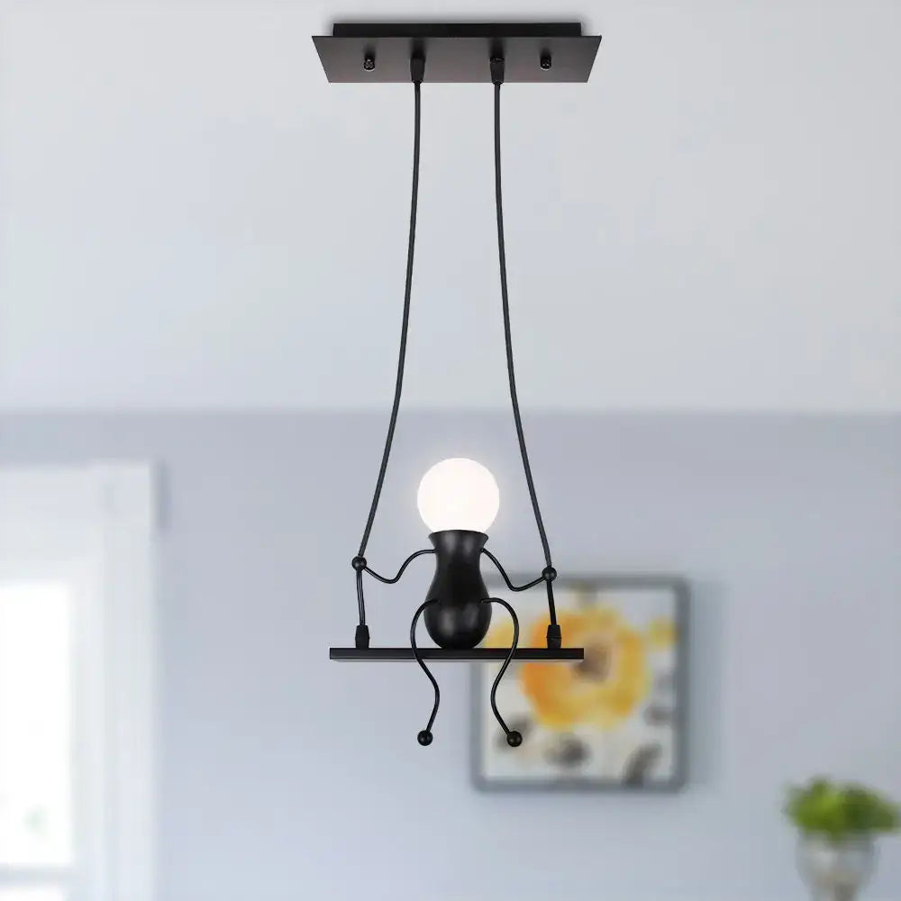 Modern black metal creative pendant light shaped like a whimsical humanoid figure holding a glowing bulb for bedroom