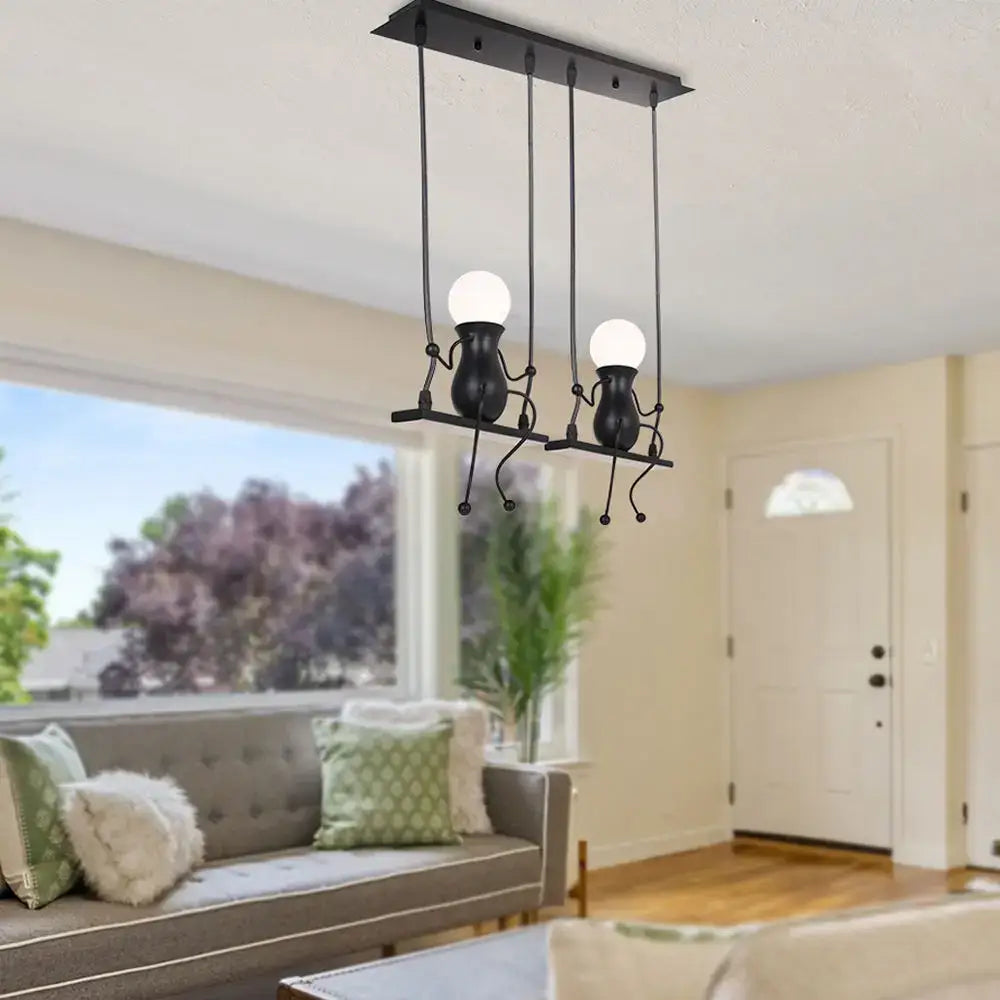 Modern black metal pendant light with two whimsical humanoid arms holding spherical bulbs for bedroom use