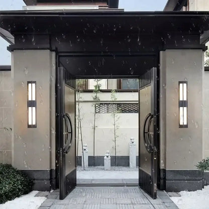 Modern black imitation marble led wall light garden sconce with vertical fixtures beside black metal double doors and circular handles