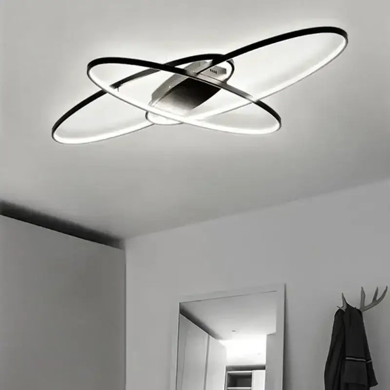 Modern black intersecting led ceiling light with circular rings ideal for decorbites elegant ceiling chandeliers in living rooms