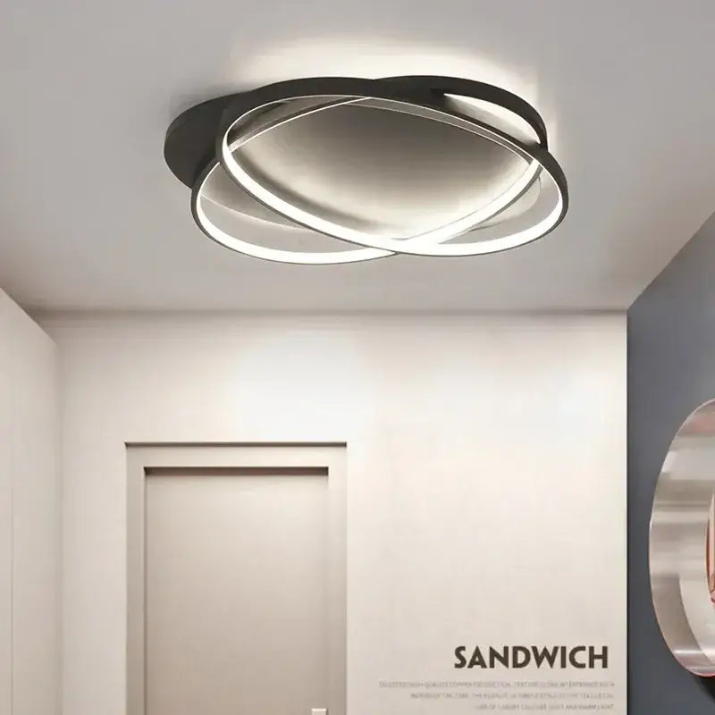 Modern black intersecting led ceiling light with intertwined circular rings for living room decorbites elegant ceiling