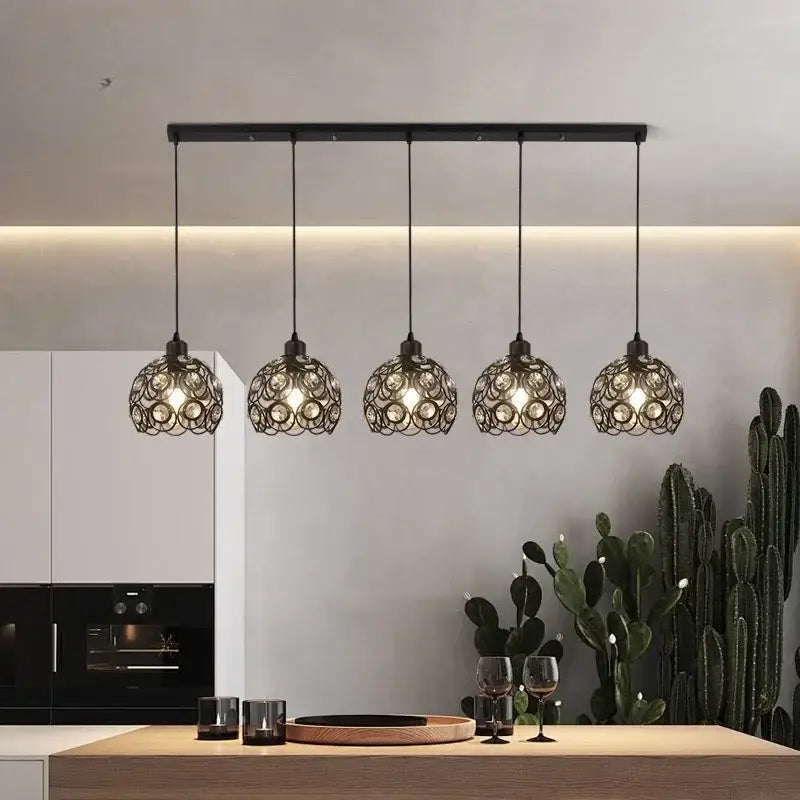 Modern black iron cage pendant lamp with intricate circular design hanging above kitchen island lighting decorbites crystal dining