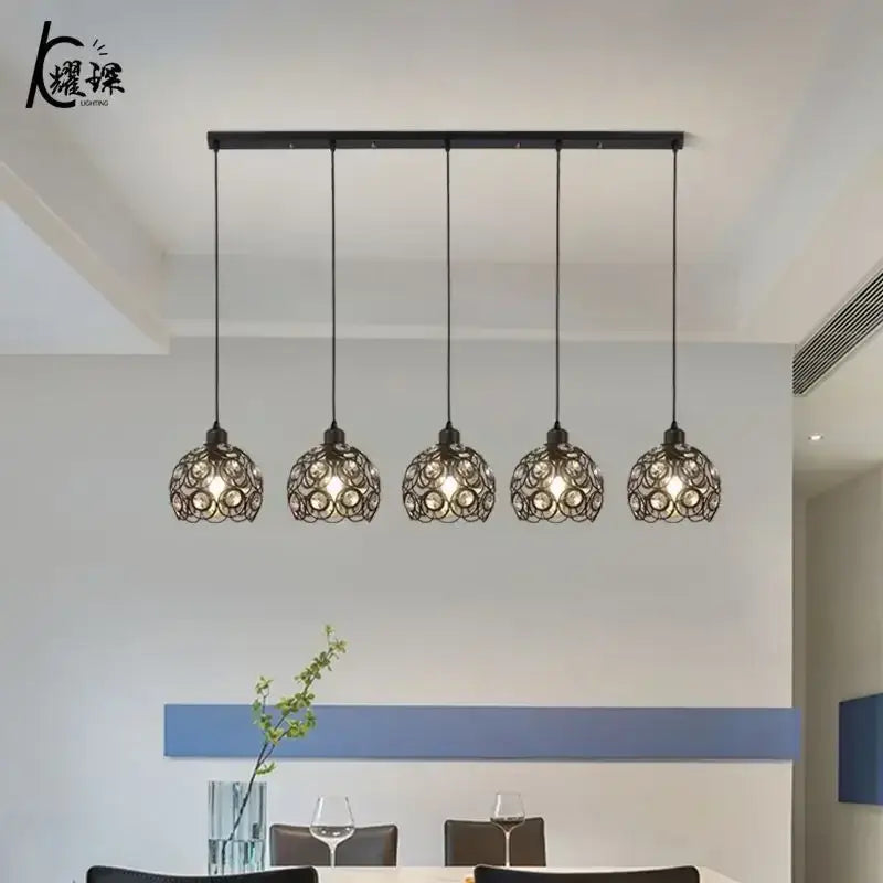 Modern black iron cage pendant lamp with five spherical shades ideal for kitchen island lighting and decorbites crystal dining