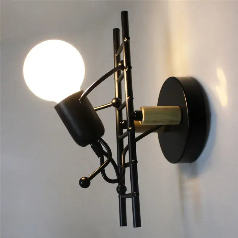 Modern black iron wall sconce with minimalist sculptural arms and spherical accents for decorbites cartoon doll kids bedroom