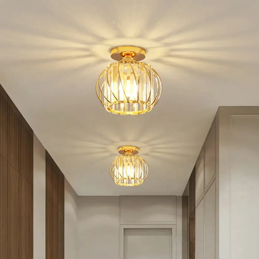 Gold-finished iron round crystal cage ceiling light with warm radiant glow for modern dining room decorbites iron round chandelier
