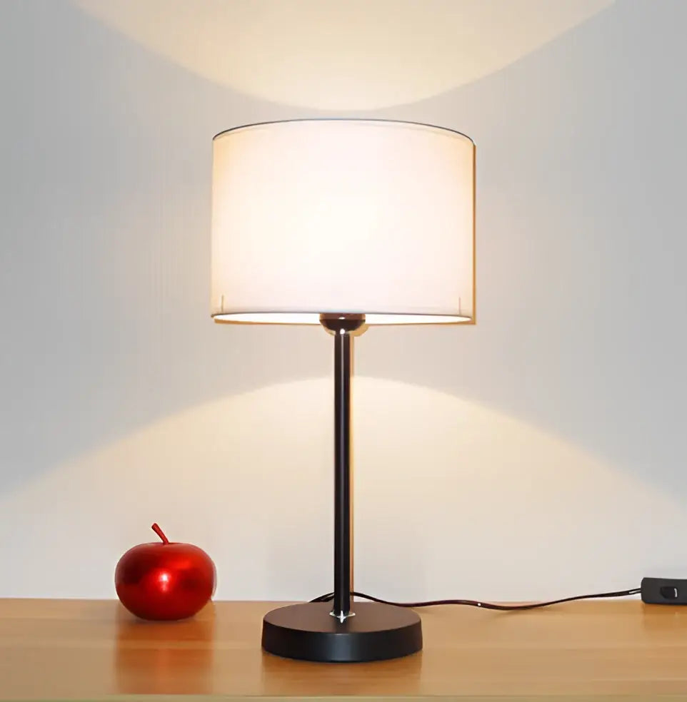 Modern black iron table lamp with cylindrical white fabric shade for bedroom by decorbites iron table